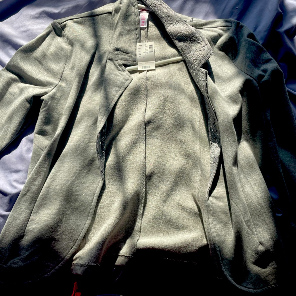 Justice brand, size 18 jacket with gems on the color portion.